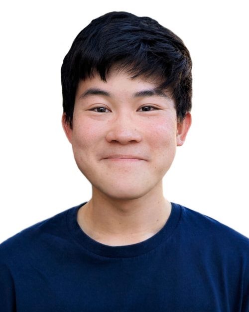 Professional headshot of a person smiling against a plain background