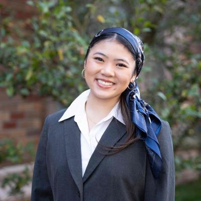 Professional headshot of a person smiling outdoors