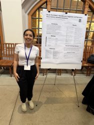 Person standing next to research poster titled Words That Matter in an indoor setting