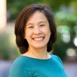 Professional headshot of Joanne smiling outdoors